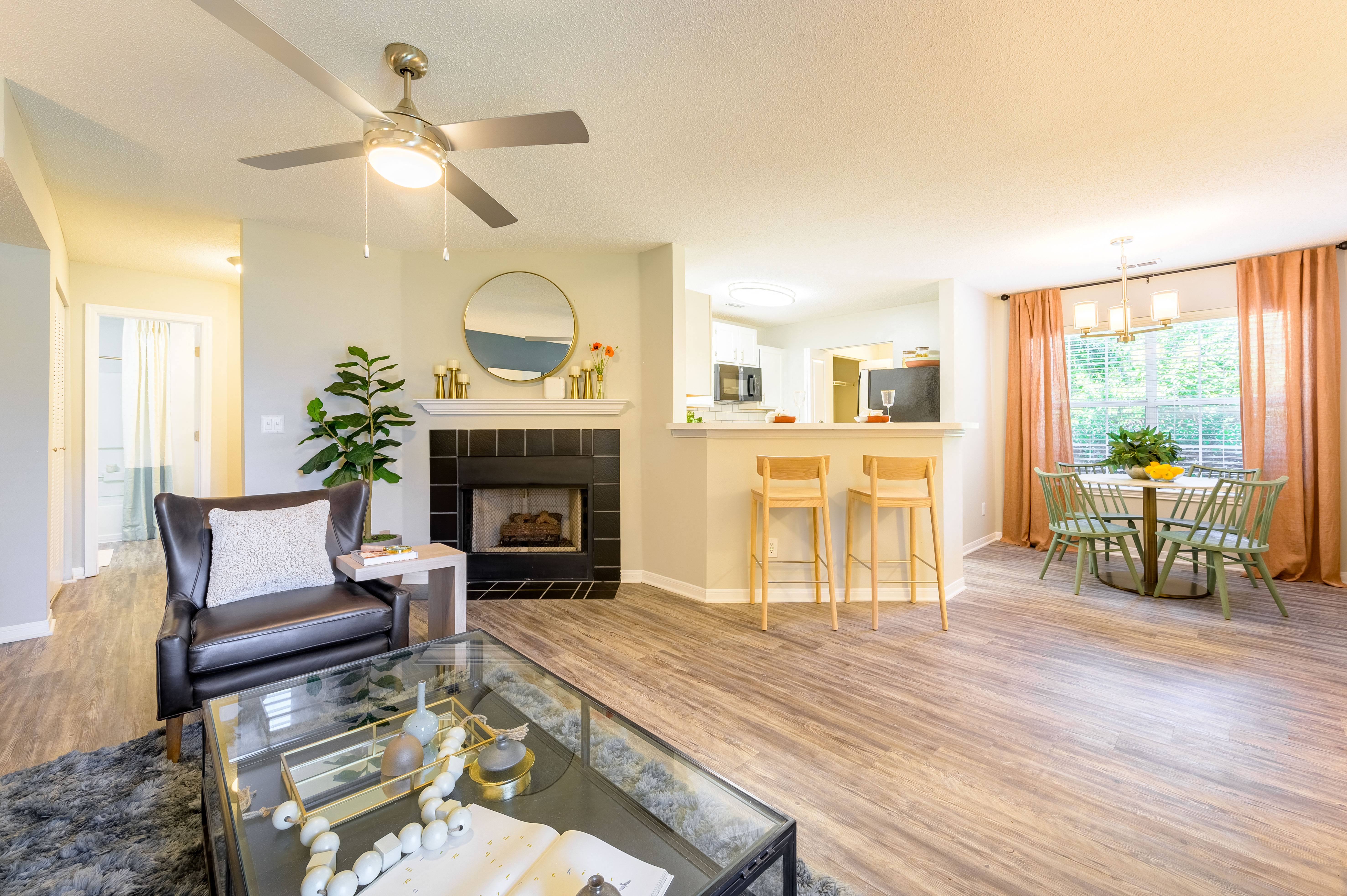 the view of a living room with a fireplace and a glass table